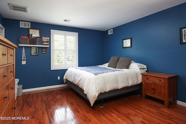 bedroom featuring wood finished floors and baseboards