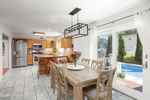 dining room with light tile patterned flooring and recessed lighting
