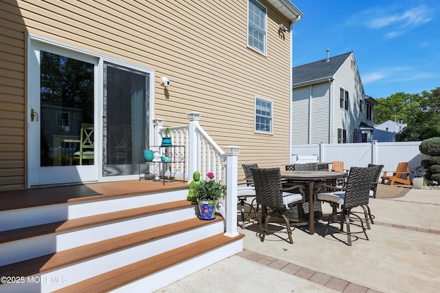 view of patio featuring fence and outdoor dining space