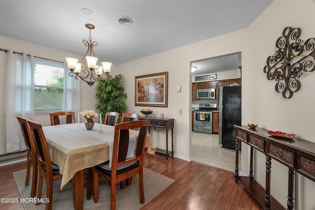 2A Jackson Ct, Whiting, NJ 08759 - dining area with a chandelier, wood finished floors, and baseboards