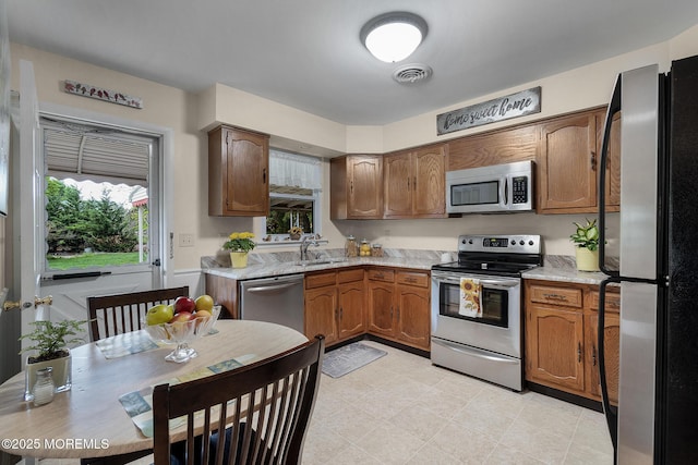 2A Jackson Ct, Whiting, NJ 08759 - kitchen featuring stainless steel appliances, a sink, light countertops, and brown cabinetry