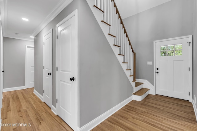 92 Sargent Rd, Freehold, NJ 07728 - foyer with ornamental molding, light wood finished floors, baseboards, stairway, and recessed lighting