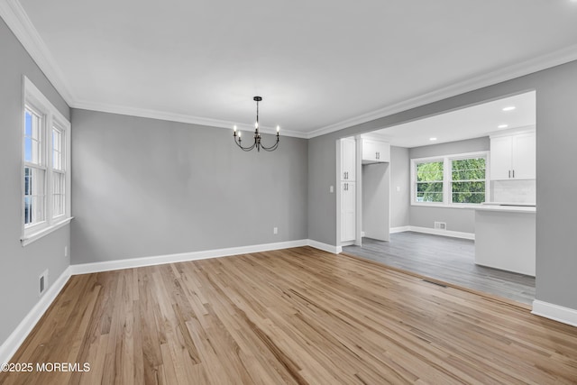 92 Sargent Rd, Freehold, NJ 07728 - empty room with a chandelier, light wood finished floors, crown molding, baseboards, and recessed lighting