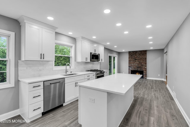 92 Sargent Rd, Freehold, NJ 07728 - kitchen with appliances with stainless steel finishes, a sink, light wood-style floors, a kitchen island, and recessed lighting