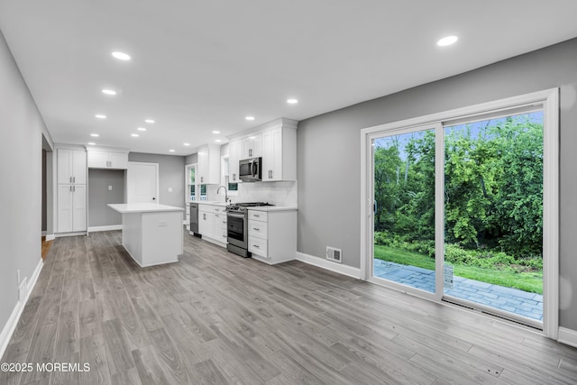 92 Sargent Rd, Freehold, NJ 07728 - kitchen featuring stainless steel appliances, a sink, baseboards, light wood-style floors, and light countertops