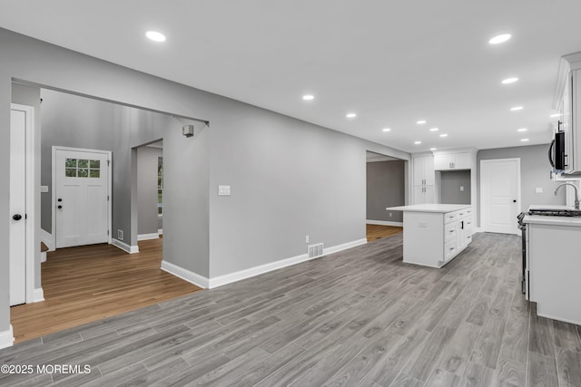 92 Sargent Rd, Freehold, NJ 07728 - kitchen with light countertops, light wood-style floors, baseboards, white cabinets, and recessed lighting