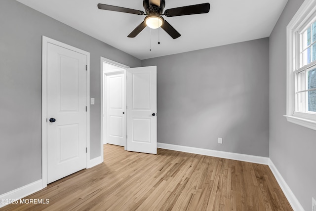 92 Sargent Rd, Freehold, NJ 07728 - unfurnished bedroom featuring light wood-type flooring, baseboards, multiple windows, and ceiling fan