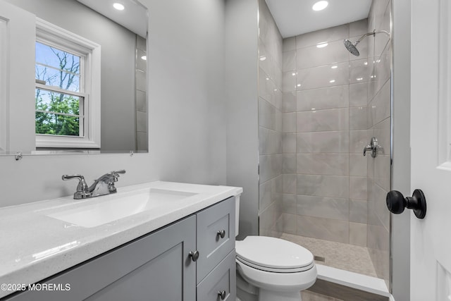 92 Sargent Rd, Freehold, NJ 07728 - bathroom featuring vanity, toilet, tiled shower, and recessed lighting