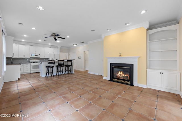 7 Spring Lake Ct, Barnegat, NJ 08005 - living area featuring crown molding, a ceiling fan, recessed lighting, a glass covered fireplace, and built in features