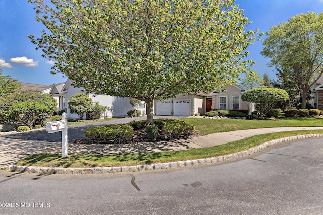 7 Spring Lake Ct, Barnegat, NJ 08005 - view of property hidden behind natural elements featuring curved driveway, a front yard, and a garage