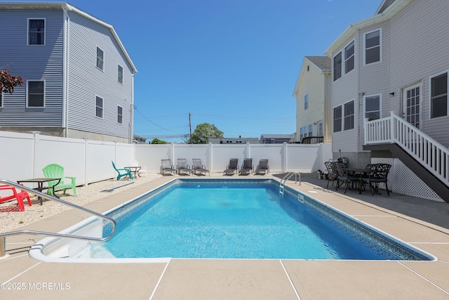 view of swimming pool with a patio and a fenced backyard