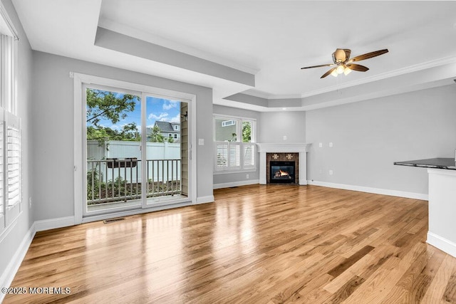 108 Locust Ave, Red Bank, NJ 07701 - unfurnished living room featuring light wood-style flooring, ceiling fan, a raised ceiling, a fireplace, and baseboards