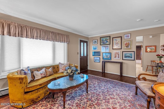 living room with crown molding, baseboards, and wood finished floors