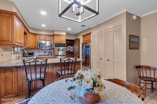 dining space with recessed lighting and ornamental molding