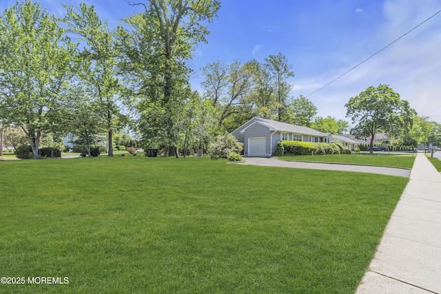 2308 Logan Rd, Ocean Twp, NJ 07712 - view of green lawn featuring driveway and an attached garage