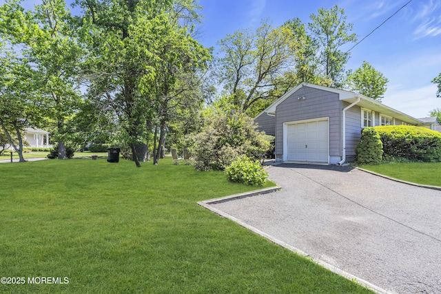 2308 Logan Rd, Ocean Twp, NJ 07712 - view of grassy yard with asphalt driveway, a garage, and an outdoor structure