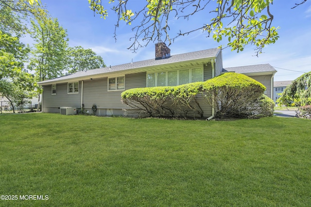 2308 Logan Rd, Ocean Twp, NJ 07712 - view of home's exterior with a yard, a chimney, and central AC
