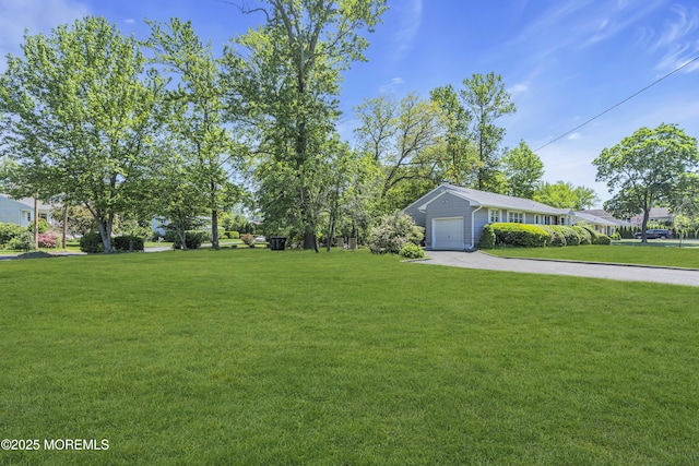 2308 Logan Rd, Ocean Twp, NJ 07712 - view of grassy yard featuring concrete driveway and an attached garage