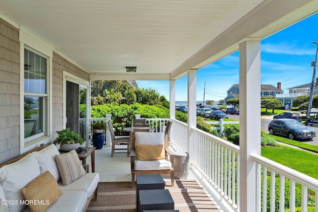 balcony featuring a porch and an outdoor hangout area