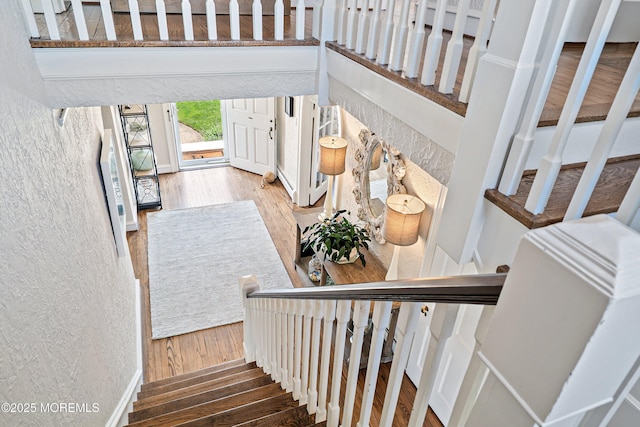 staircase featuring wood finished floors