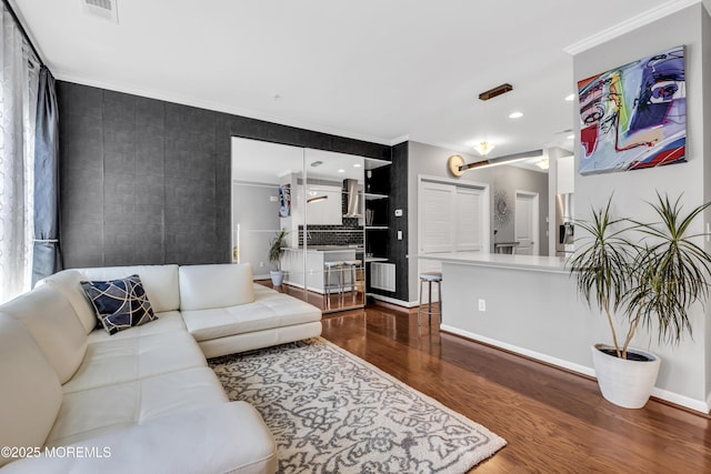 7 Samantha Dr, Tinton Falls, NJ 07712 - living area featuring wood finished floors, ornamental molding, recessed lighting, and baseboards