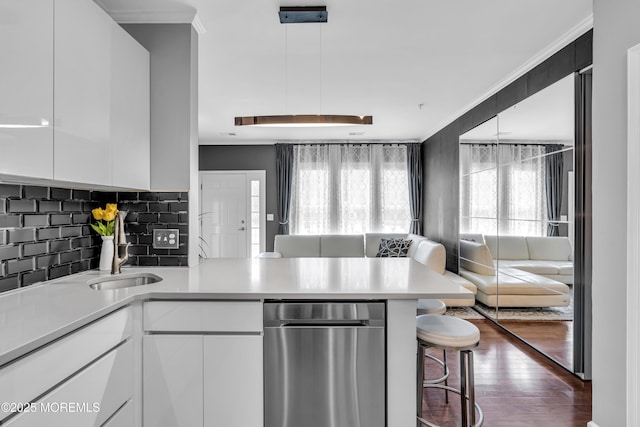 7 Samantha Dr, Tinton Falls, NJ 07712 - kitchen featuring open floor plan, a sink, a peninsula, tasteful backsplash, and white cabinets