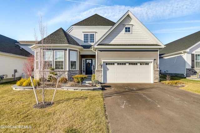 22 Keeneland Rd, New Egypt, NJ 08533 - view of front facade with asphalt driveway, stone siding, a front yard, and a shingled roof