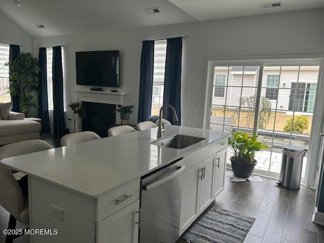 22 Keeneland Rd, New Egypt, NJ 08533 - kitchen featuring stainless steel dishwasher, a sink, open floor plan, healthy amount of natural light, and vaulted ceiling