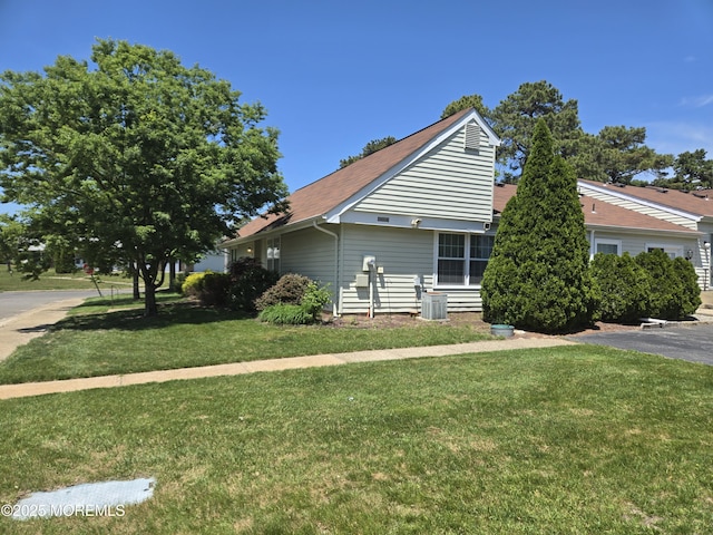 439D Chesterfield Ct, Manchester, NJ 08759 - view of home's exterior featuring a lawn, central AC unit, and roof with shingles