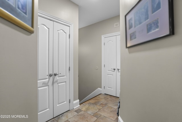 821 Woodland Dr, Lakewood, NJ 08701 - hall featuring baseboards and stone tile floors