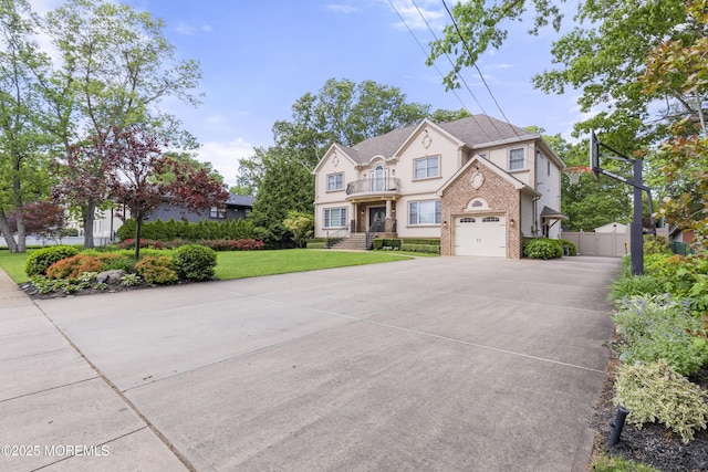 821 Woodland Dr, Lakewood, NJ 08701 - view of front facade with driveway, stucco siding, a balcony, and a garage