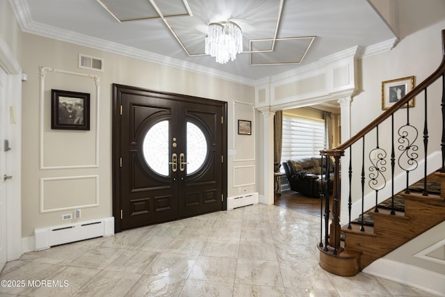 821 Woodland Dr, Lakewood, NJ 08701 - foyer entrance with a baseboard heating unit, crown molding, stairway, a chandelier, and decorative columns