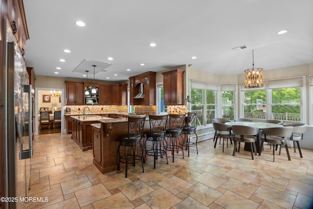 821 Woodland Dr, Lakewood, NJ 08701 - kitchen featuring a chandelier, backsplash, light stone countertops, wall chimney range hood, and recessed lighting