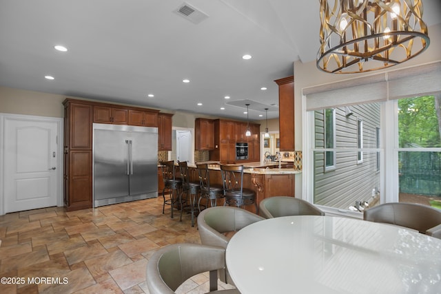 821 Woodland Dr, Lakewood, NJ 08701 - dining space with light stone finish floors, recessed lighting, and a chandelier