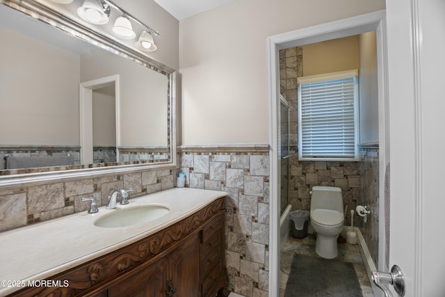 821 Woodland Dr, Lakewood, NJ 08701 - full bathroom featuring wainscoting, toilet, vanity, and tile walls