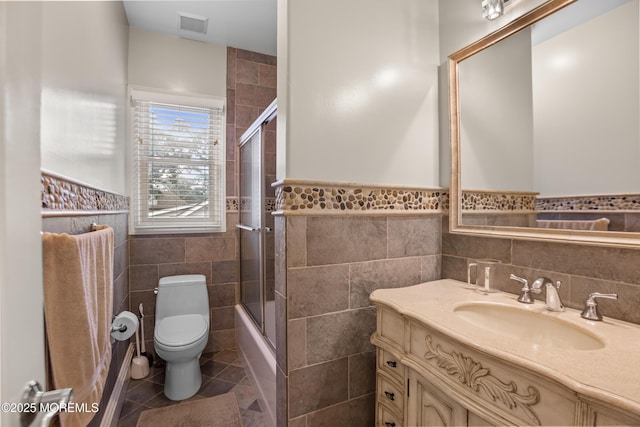 821 Woodland Dr, Lakewood, NJ 08701 - full bath featuring tile walls, tile patterned flooring, vanity, toilet, and a wainscoted wall