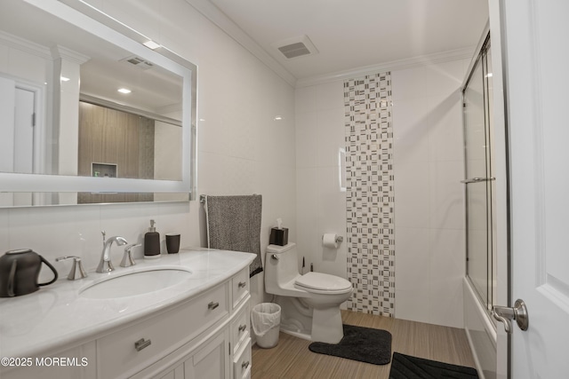 821 Woodland Dr, Lakewood, NJ 08701 - full bath with toilet, vanity, wood finished floors, crown molding, and enclosed tub / shower combo