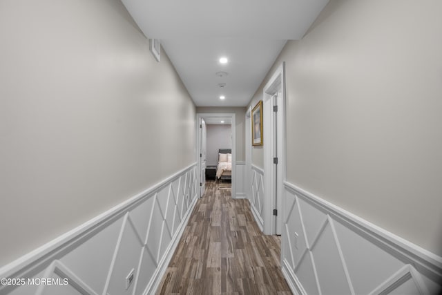 821 Woodland Dr, Lakewood, NJ 08701 - corridor featuring recessed lighting, wainscoting, dark wood-style floors, and a decorative wall