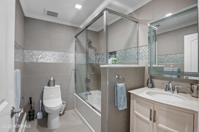 821 Woodland Dr, Lakewood, NJ 08701 - bathroom with tile walls, crown molding, toilet, enclosed tub / shower combo, and vanity