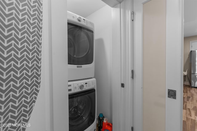 821 Woodland Dr, Lakewood, NJ 08701 - laundry room featuring estacked washer and dryer and wood finished floors