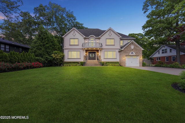 821 Woodland Dr, Lakewood, NJ 08701 - view of front of house featuring a balcony, stucco siding, a front yard, and driveway