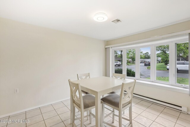 1164B Argyll Cir, Lakewood, NJ 08701 - dining space featuring a baseboard radiator, light tile patterned floors, and plenty of natural light