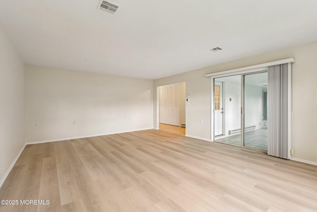 1164B Argyll Cir, Lakewood, NJ 08701 - empty room featuring baseboard heating and light wood-style flooring