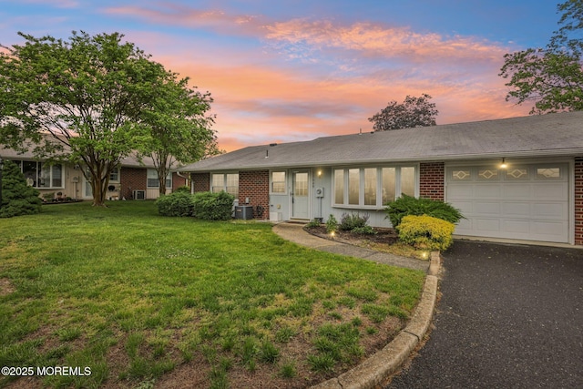 1164B Argyll Cir, Lakewood, NJ 08701 - ranch-style house featuring a garage, brick siding, a front lawn, and asphalt driveway
