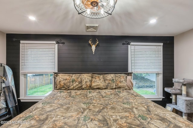 bedroom featuring multiple windows and recessed lighting