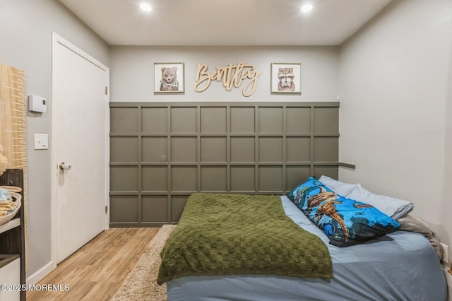 bedroom with wood finished floors and recessed lighting