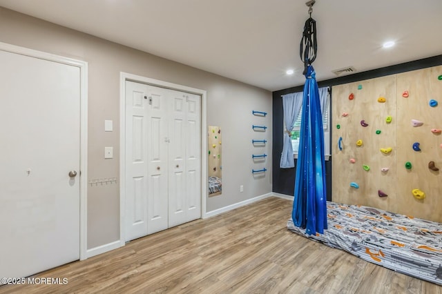 entrance foyer with wood finished floors, baseboards, and recessed lighting