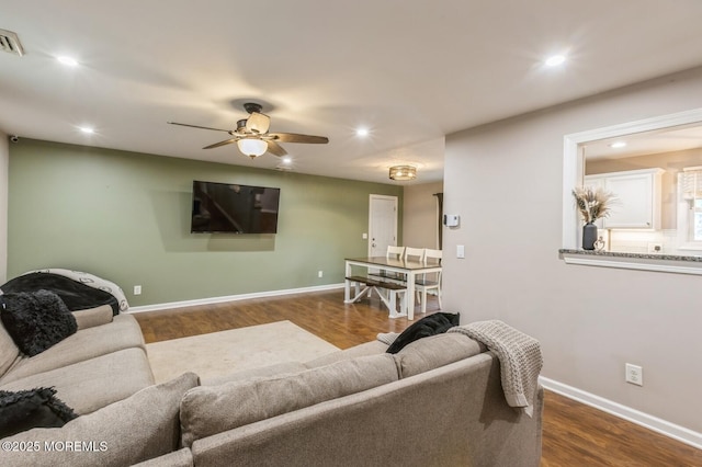 living room featuring wood finished floors, recessed lighting, ceiling fan, and baseboards
