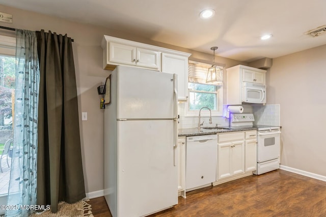 kitchen with white appliances, a sink, stone countertops, recessed lighting, and backsplash