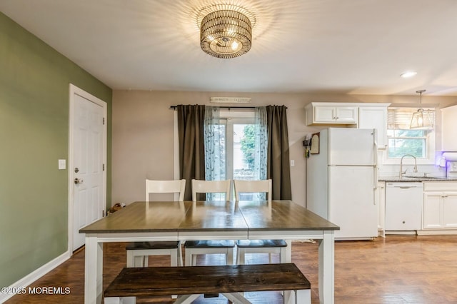 dining area featuring a chandelier, plenty of natural light, dark wood finished floors, and recessed lighting